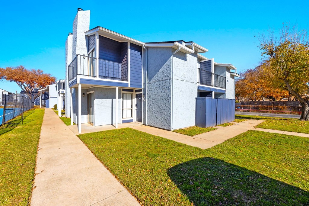 A modern two-story house with a blue exterior and a white roof.