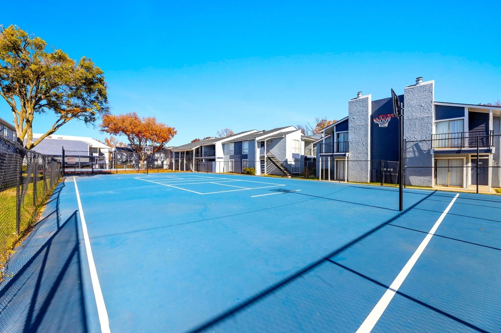 A tennis court with a white line in the middle of it.