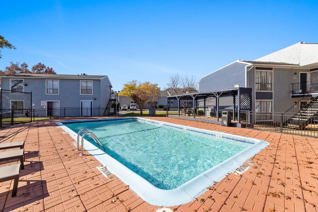 A small pool surrounded by a brick patio.