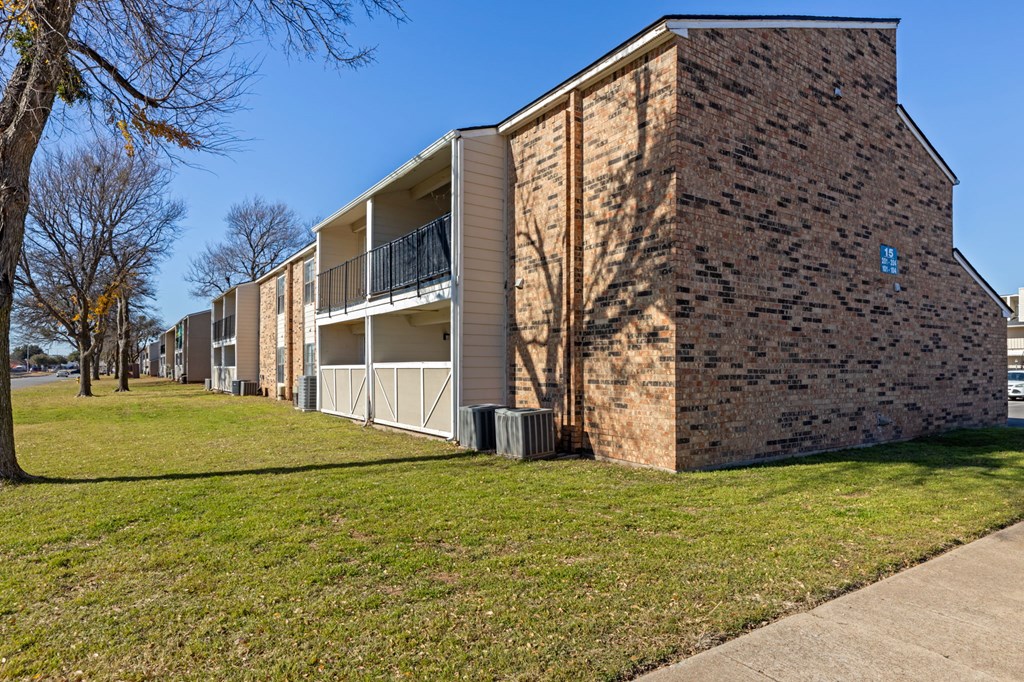 A building with a brick facade and a balcony.