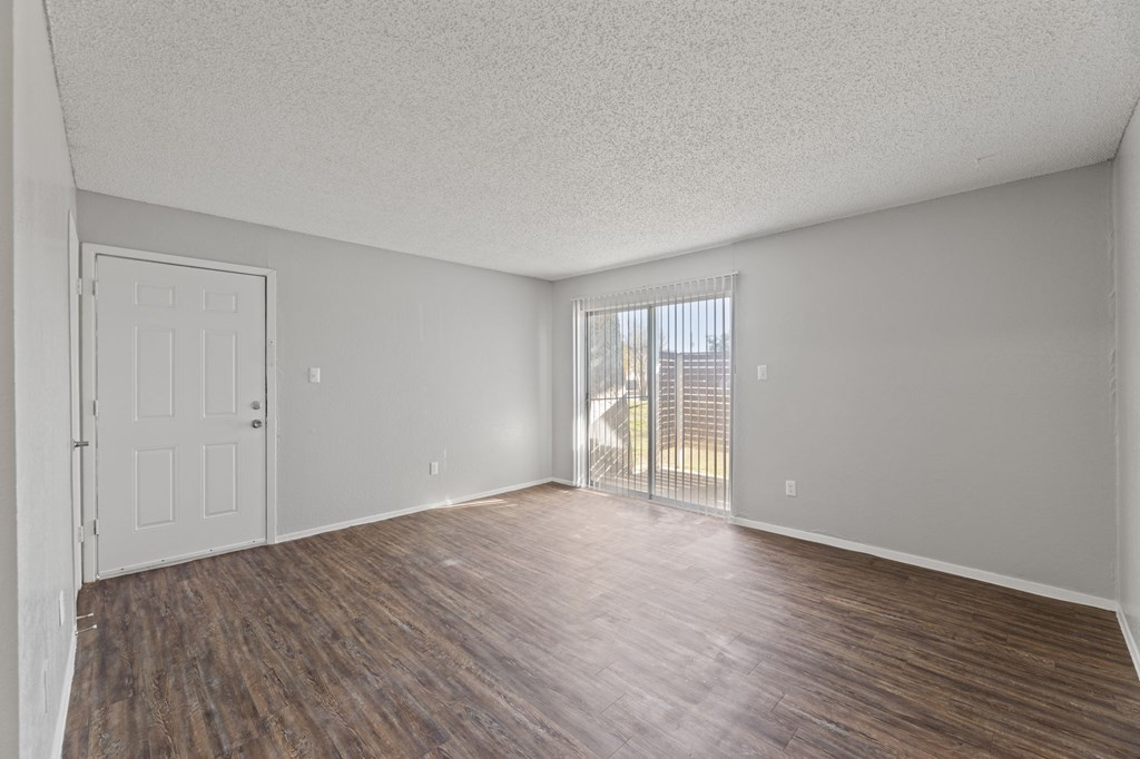 A room with a white door and a window with blinds.