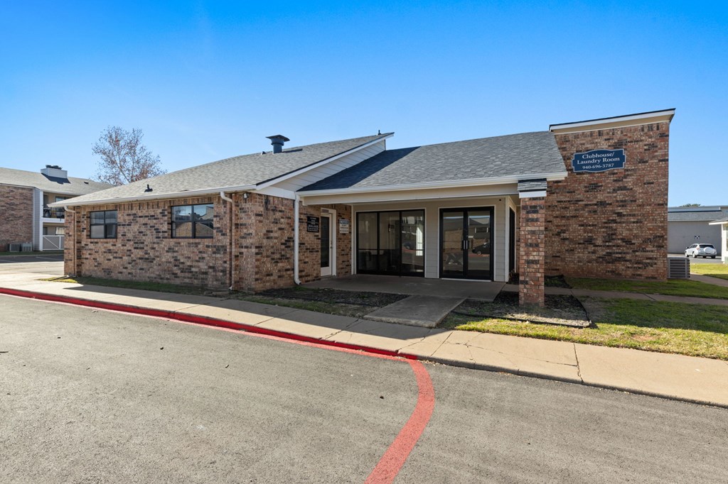 A building with a brick facade and a sign above the entrance.