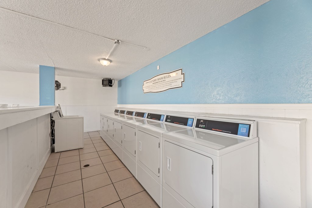 A row of washing machines in a laundromat.