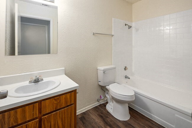 a bathroom with a toilet and a sink and a bath tub