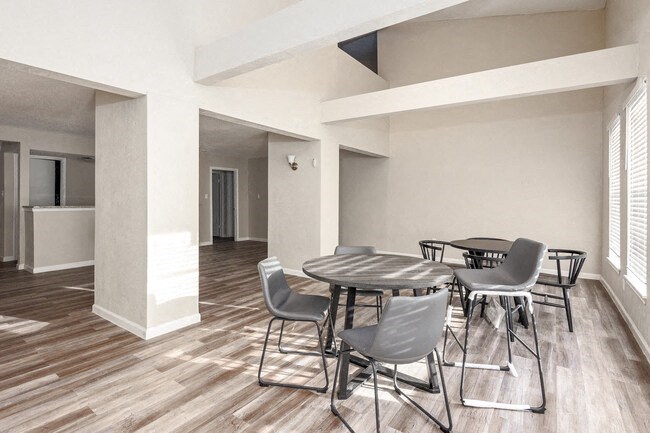 a dining room with a table and chairs