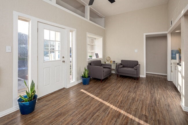 a living room with two chairs and a door