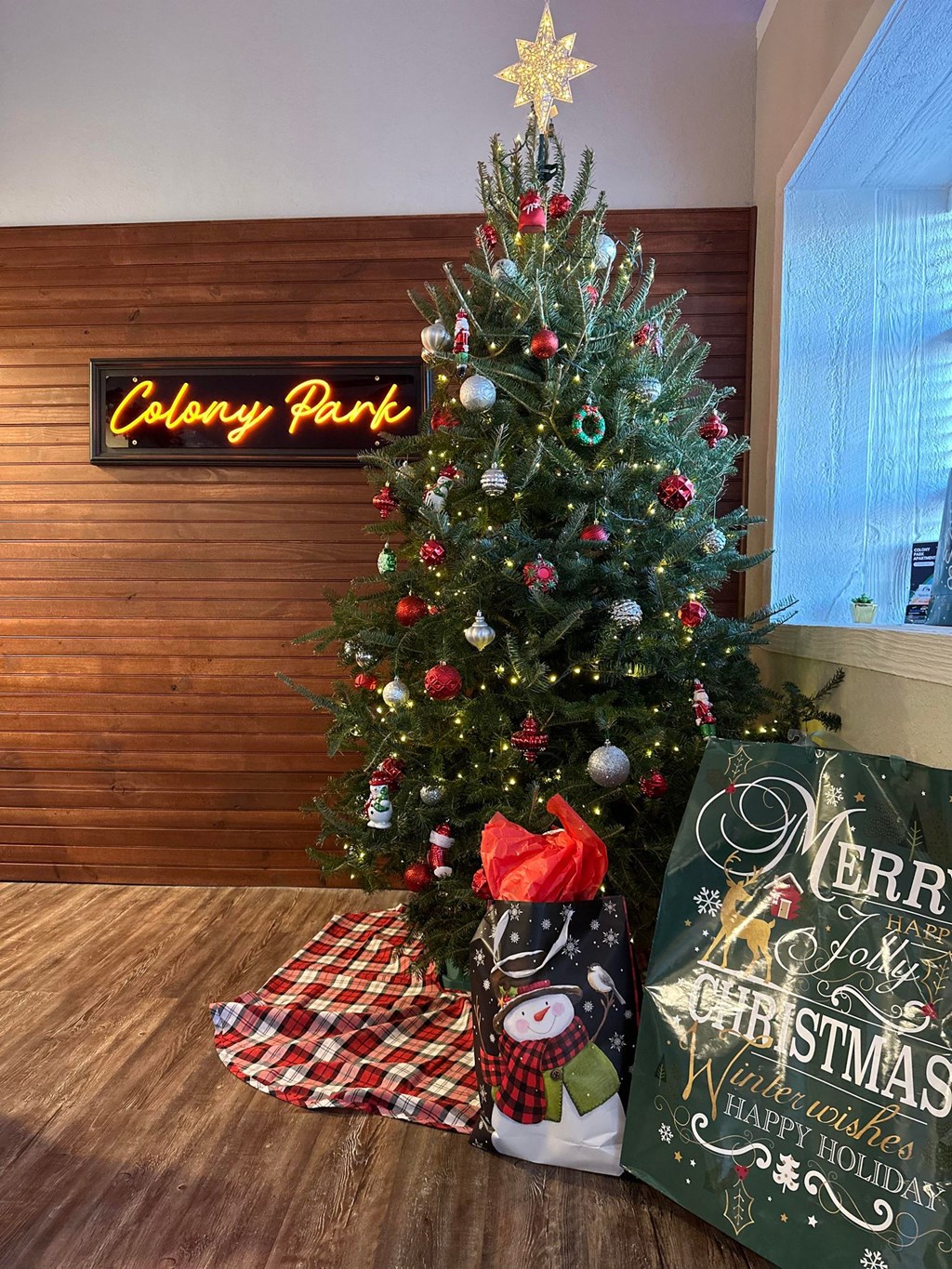 a christmas tree in a lobby with presents