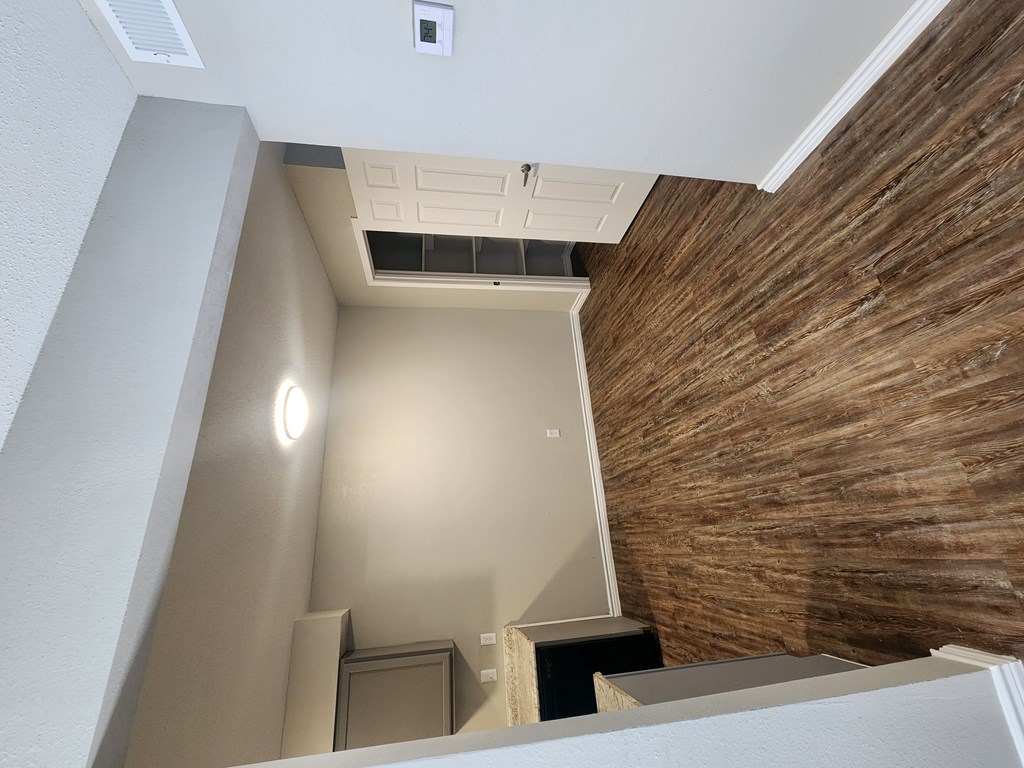 A room with a wooden wall and a white ceiling.