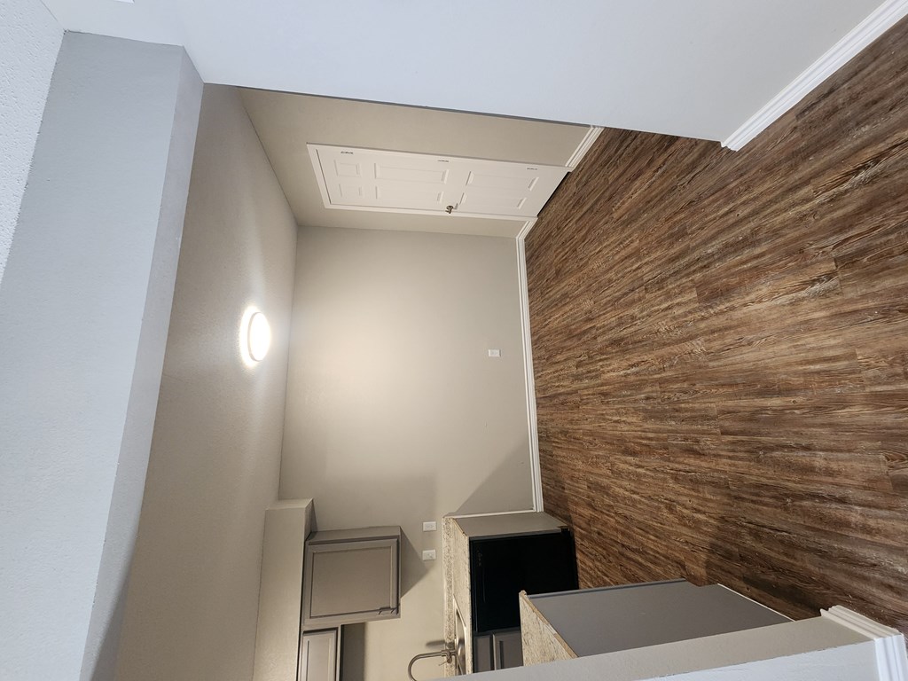 A room with a wooden wall and a white ceiling.