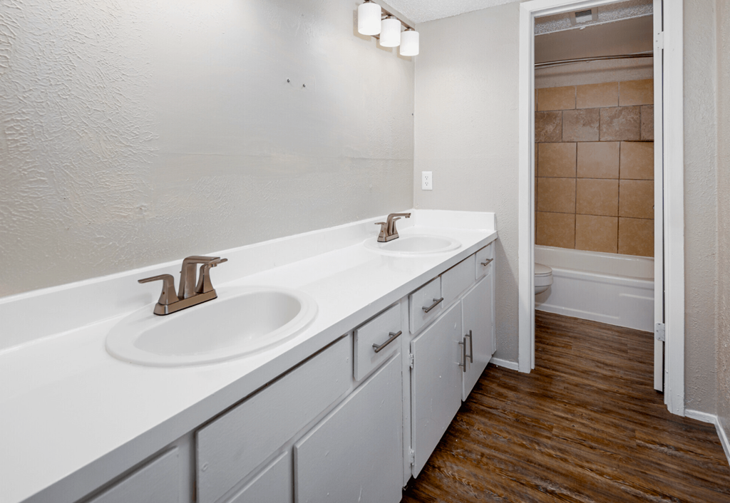A bathroom with a white sink and a white counter top.
