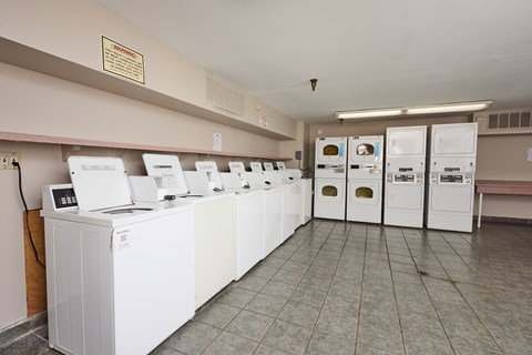 A row of washing machines in a laundromat.