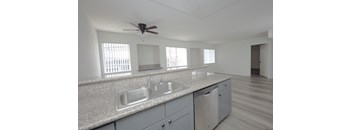 A modern kitchen with a fan on the ceiling.