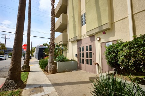 A building with a pink door and a sign that says "STOP".