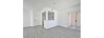 A white room with a bar counter and a mirror.