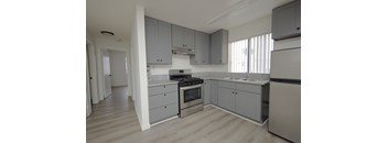 A modern kitchen with a stove, oven, and sink.