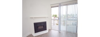 A room with a fireplace and sliding glass doors.