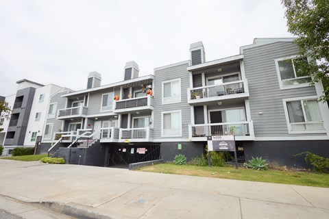 Apartment building with a black gate in front.