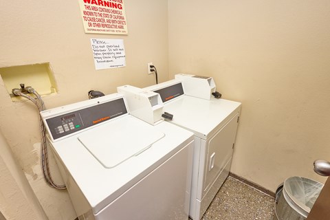 A washing machine and dryer in a small room.