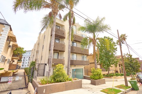 A residential area with apartment buildings and palm trees.