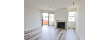 A room with a fireplace and sliding glass doors.