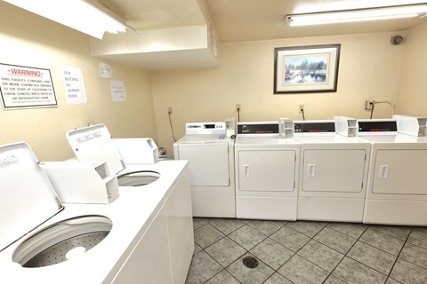 A row of washing machines in a laundromat.