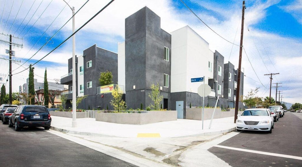 a city street with cars parked in front of a building