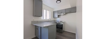 A kitchen with a granite countertop and stainless steel appliances.