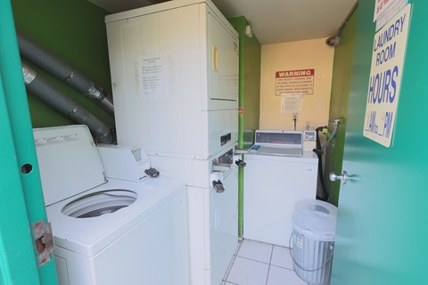 A small laundry room with a washer and dryer.
