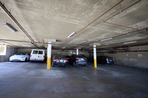 A parking garage with cars parked in it.