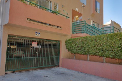 A green gate blocks the entrance to a building.