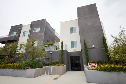 A modern house with a black and white exterior is for sale.