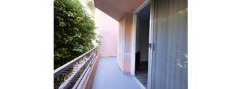 A balcony with a glass door and a railing.