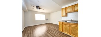 A room with wooden floors and a ceiling fan.