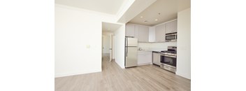 A kitchen with white cabinets and stainless steel appliances.