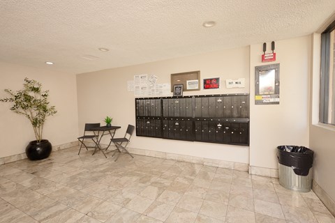A room with a table and chairs and a mailbox.
