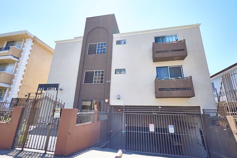 A building with a brown gate in front of it.