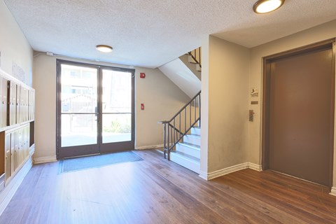 A room with a staircase and a door.