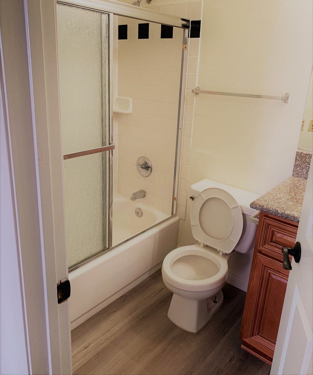 a bathroom with a toilet and a shower