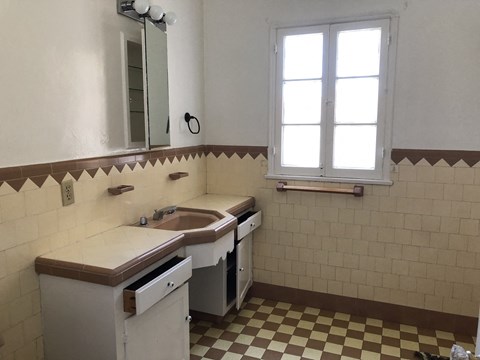 an old kitchen with a sink and a window