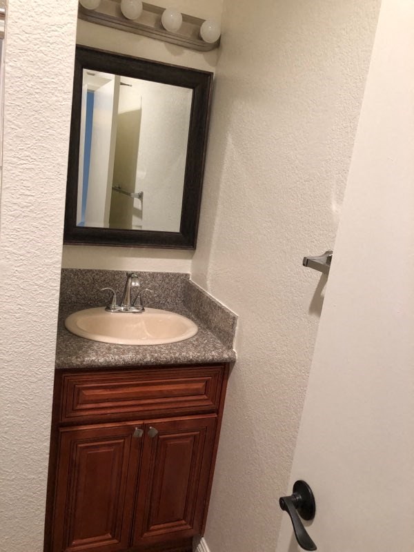 a small bathroom with a sink and a mirror