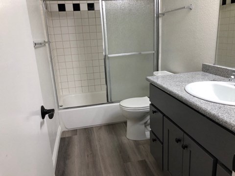 a bathroom with a sink toilet and shower