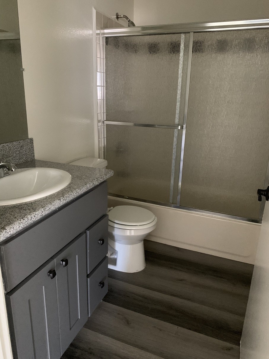 a bathroom with a sink toilet and shower