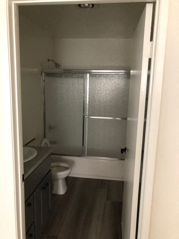 a bathroom with a toilet and a sink and a shower