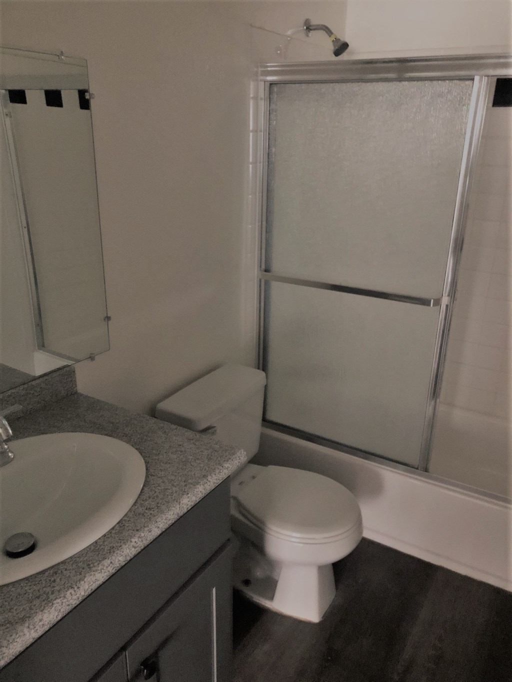 a bathroom with a toilet and a sink and a shower