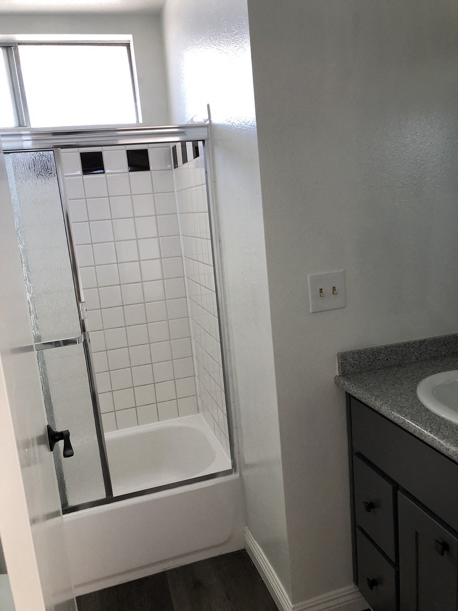 a small bathroom with a shower and a sink