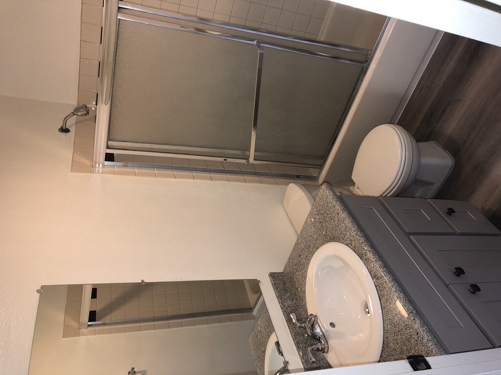 a small bathroom with a toilet and a shower