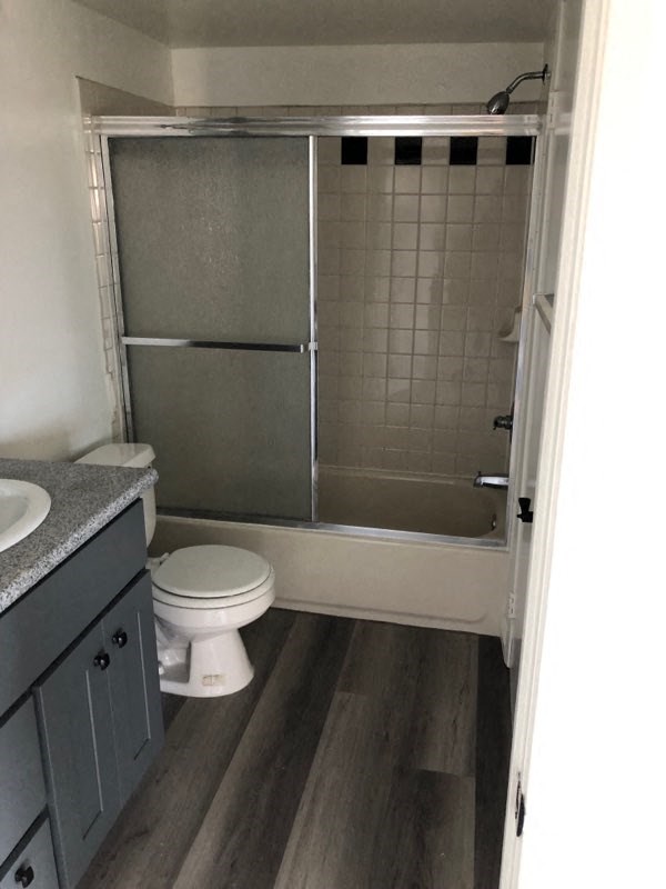 a bathroom with a toilet and a shower