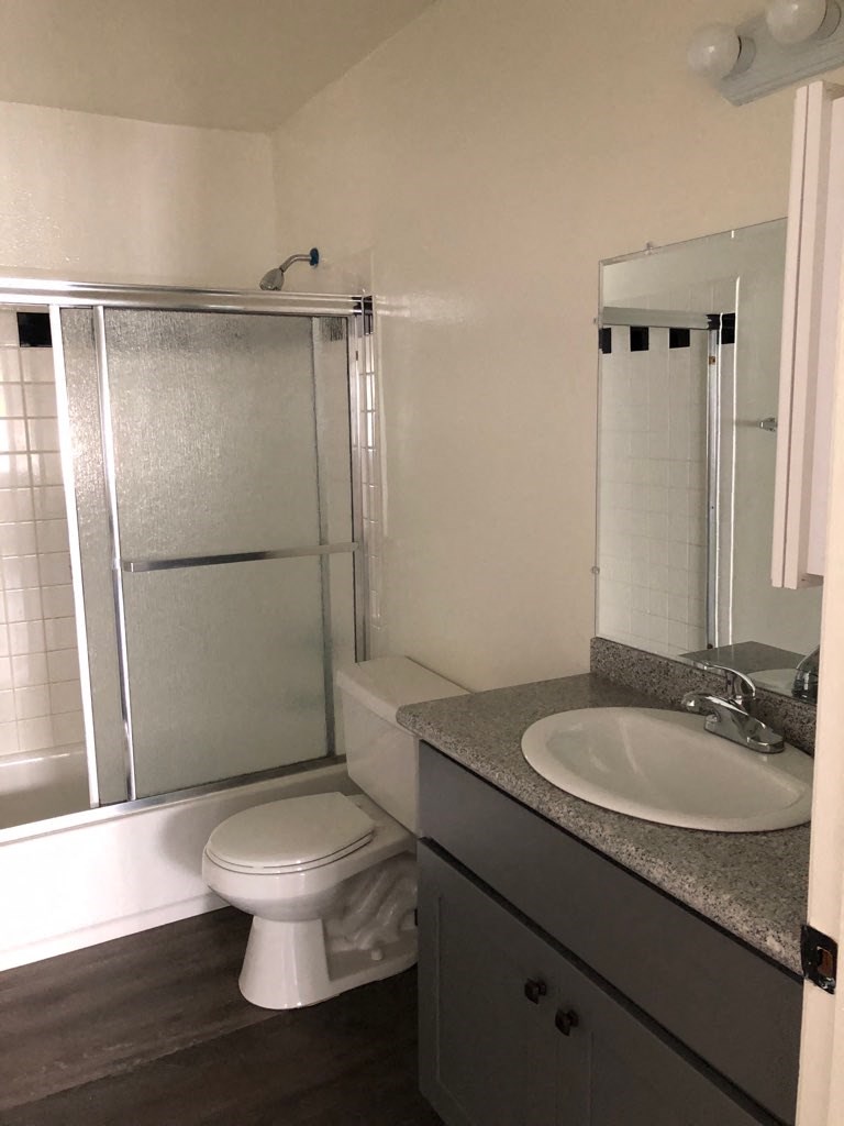 a bathroom with a sink toilet and shower