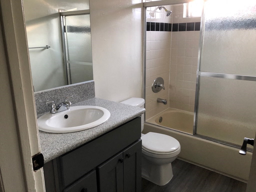 a bathroom with a sink toilet and shower