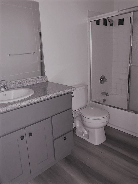 a bathroom with a toilet and a sink and a shower